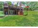 Wide shot of the back exterior of the home with a deck, patio, and stairs to the backyard at 260 Waverly Hall Dr, Roswell, GA 30075