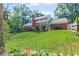 A wide view of the backyard and deck area with an orange umbrella and a brick chimney at 260 Waverly Hall Dr, Roswell, GA 30075