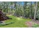 Expansive backyard featuring lush greenery, mature trees, and a multi-level deck, perfect for outdoor living at 260 Waverly Hall Dr, Roswell, GA 30075