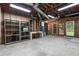 Unfinished basement with exposed ceiling, open shelving, and a functional workspace at 260 Waverly Hall Dr, Roswell, GA 30075