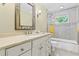 Bright bathroom with white vanity, sleek fixtures, and a tiled shower-tub combination at 260 Waverly Hall Dr, Roswell, GA 30075