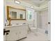 Bright bathroom featuring a tiled shower, vanity, and natural light at 260 Waverly Hall Dr, Roswell, GA 30075