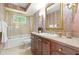 This bathroom offers a marble vanity top, mirror, and a shower-tub combination at 260 Waverly Hall Dr, Roswell, GA 30075