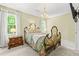 Charming bedroom with a wrought-iron bed, hardwood dresser, and a bright window view at 260 Waverly Hall Dr, Roswell, GA 30075