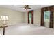 Large bedroom with natural light, ceiling fan, and neutral carpet perfect for relaxation at 260 Waverly Hall Dr, Roswell, GA 30075