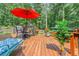 Outdoor deck features a bench with cushions, potted plants, and a grill for outdoor cooking and entertaining at 260 Waverly Hall Dr, Roswell, GA 30075