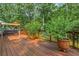 Wide shot of an outdoor deck featuring multiple potted plants and an outdoor swing at 260 Waverly Hall Dr, Roswell, GA 30075
