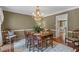 Elegant dining room featuring a crystal chandelier and hardwood floors, perfect for hosting dinner parties at 260 Waverly Hall Dr, Roswell, GA 30075