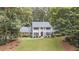 Stately two-story home with a manicured lawn, classic columns, and mature landscaping at 260 Waverly Hall Dr, Roswell, GA 30075