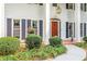 Close-up of the front entrance with a mahogany front door, decorative bushes and well-manicured landscaping at 260 Waverly Hall Dr, Roswell, GA 30075