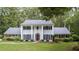 Traditional two-story home with white columns, black shutters, manicured lawn, and mature landscaping at 260 Waverly Hall Dr, Roswell, GA 30075