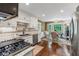 Bright kitchen featuring stainless steel appliances, granite countertops, and a breakfast nook with bay window at 260 Waverly Hall Dr, Roswell, GA 30075