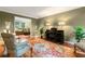 Comfortable living room with hardwood floors, decorative rug, crown molding and plenty of light at 260 Waverly Hall Dr, Roswell, GA 30075