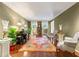 Living room featuring hardwood floors, a decorative rug, a piano and crown molding at 260 Waverly Hall Dr, Roswell, GA 30075