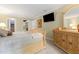Bright main bedroom featuring a sleigh bed, wall-mounted TV, and a classic wooden dresser with mirror at 260 Waverly Hall Dr, Roswell, GA 30075