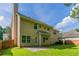 Tan two-story home exterior with a patio and a grassy, fenced backyard at 5018 Upper Elm St, Atlanta, GA 30349