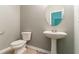 Powder room features a pedestal sink, neutral decor, and a modern design for convenience and style at 5018 Upper Elm St, Atlanta, GA 30349