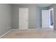 Bedroom featuring neutral walls and carpet with two access doors at 5018 Upper Elm St, Atlanta, GA 30349
