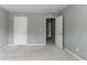 Neutral bedroom showcasing two entry doors and light colored carpet at 5018 Upper Elm St, Atlanta, GA 30349
