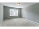 Carpeted bedroom featuring a large window with natural light at 5018 Upper Elm St, Atlanta, GA 30349