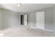 Spacious bedroom featuring carpet, neutral walls and an access door at 5018 Upper Elm St, Atlanta, GA 30349