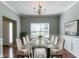Elegant dining room featuring modern table setting, wainscoting, chandelier and hardwood floors at 5018 Upper Elm St, Atlanta, GA 30349