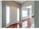 Inviting foyer with a white front door, sidelights, and hardwood floors leads into a naturally lit room at 5018 Upper Elm St, Atlanta, GA 30349