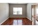 Bright living room features hardwood floors, a large window, and neutral paint creating a cozy atmosphere at 5018 Upper Elm St, Atlanta, GA 30349