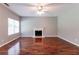 Spacious living room with hardwood floors, fireplace, and a ceiling fan offers a comfortable area at 5018 Upper Elm St, Atlanta, GA 30349