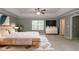 Spacious bedroom with a tray ceiling, neutral decor, and a large window, offering a serene retreat at 5018 Upper Elm St, Atlanta, GA 30349