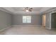 Spacious main bedroom featuring plush carpet, tray ceiling, and abundant natural light for relaxation at 5018 Upper Elm St, Atlanta, GA 30349