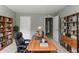 Home office with a large desk, shelving units, and neutral walls, creating a productive workspace at 5018 Upper Elm St, Atlanta, GA 30349