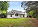 Beautiful backyard showcasing the exterior of the home with mature trees at 5315 Bentley Hall Dr, Alpharetta, GA 30005