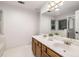 Bright bathroom featuring a double vanity, a large mirror, and tile flooring at 5315 Bentley Hall Dr, Alpharetta, GA 30005