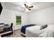 Bright bedroom features a bed with blue accents and a desk at 5315 Bentley Hall Dr, Alpharetta, GA 30005