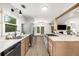 Modern kitchen features stainless steel appliances, sleek countertops, and natural wood cabinets with backyard views at 5315 Bentley Hall Dr, Alpharetta, GA 30005