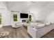 Spacious living room with cozy fireplace and abundant natural light from the windows at 5315 Bentley Hall Dr, Alpharetta, GA 30005