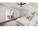 Bright main bedroom featuring a large bed, white walls, and an ensuite bathroom at 5315 Bentley Hall Dr, Alpharetta, GA 30005