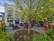Relaxing outdoor seating area with picnic tables and vibrant landscaping at Cherry Street Brewpub at 5315 Bentley Hall Dr, Alpharetta, GA 30005
