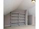 Attic space featuring shelving units and a modern light fixture at 1015 Buckeye Ln, Villa Rica, GA 30180