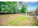 Large backyard with mature trees, a playset, and a wooden fence, creating a private and inviting outdoor space for recreation at 1015 Buckeye Ln, Villa Rica, GA 30180