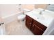 Well-lit bathroom featuring a vanity with a sink, toilet, and tub at 1015 Buckeye Ln, Villa Rica, GA 30180