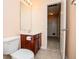 Bathroom with a vanity, mirror, toilet, and doorway to additional space at 1015 Buckeye Ln, Villa Rica, GA 30180
