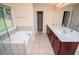 Large bathroom with double vanity, large mirror, and separate tub at 1015 Buckeye Ln, Villa Rica, GA 30180