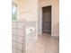 Bright bathroom featuring a large tub and an open view into the closet at 1015 Buckeye Ln, Villa Rica, GA 30180