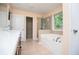 Bathroom showcasing a separate shower and large tub, plus closet access at 1015 Buckeye Ln, Villa Rica, GA 30180