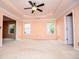 Spacious bedroom with carpet floors, a tray ceiling, and natural light from two windows at 1015 Buckeye Ln, Villa Rica, GA 30180