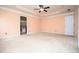 Expansive bedroom features a ceiling fan, carpet flooring and views of an ensuite bathroom at 1015 Buckeye Ln, Villa Rica, GA 30180