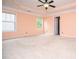 Large bedroom with carpet floors, tray ceiling, and a ceiling fan at 1015 Buckeye Ln, Villa Rica, GA 30180