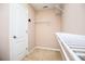 Walk-in closet featuring carpet and built-in white shelving at 1015 Buckeye Ln, Villa Rica, GA 30180